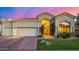 Charming home featuring a beautiful front yard, lush plants, and a two-car garage at 7439 E Beryl Ave, Scottsdale, AZ 85258