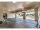 Spacious garage with ample storage cabinets and two open doors, showcasing the neighborhood at 7439 E Beryl Ave, Scottsdale, AZ 85258