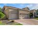 Spacious three-car garage featuring a wide driveway and mature landscaping around the home at 7439 E Beryl Ave, Scottsdale, AZ 85258