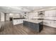Spacious kitchen with stainless steel appliances, large island, modern cabinets and countertops at 7439 E Beryl Ave, Scottsdale, AZ 85258