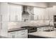 Modern kitchen with white cabinets, stainless steel appliances, and dark countertops at 7439 E Beryl Ave, Scottsdale, AZ 85258