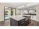 Modern kitchen featuring a large island, stainless steel appliances, and direct access to the outdoor patio at 7439 E Beryl Ave, Scottsdale, AZ 85258