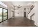 Spacious living room with soaring ceilings, modern lighting, wood floors, and views of the pool at 7439 E Beryl Ave, Scottsdale, AZ 85258