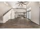 Bright living room with a grand staircase, high ceilings, wood-look floors, and multiple windows at 7439 E Beryl Ave, Scottsdale, AZ 85258