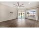 Bright living room boasts sliding glass doors to the pool and light-filtering curtains at 7439 E Beryl Ave, Scottsdale, AZ 85258