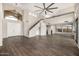 Spacious living room with wood floors, a modern ceiling fan, and many windows at 7439 E Beryl Ave, Scottsdale, AZ 85258