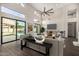 Bright living room featuring high ceilings, a modern ceiling fan, and patio access to the pool at 7439 E Beryl Ave, Scottsdale, AZ 85258
