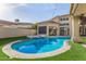 Backyard pool with surrounding turf, lounge area, and seamless indoor/outdoor transitions at 7439 E Beryl Ave, Scottsdale, AZ 85258
