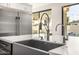 Kitchen sink with stainless steel appliances and a view of the backyard pool at 7439 E Beryl Ave, Scottsdale, AZ 85258