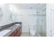 Bathroom featuring granite countertops, white cabinets, a shower with glass doors and tile floors at 7970 E Camelback Rd # 604, Scottsdale, AZ 85251