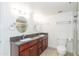 Bathroom featuring granite countertops, white cabinets, a shower with glass doors, double sinks and tile floors at 7970 E Camelback Rd # 604, Scottsdale, AZ 85251