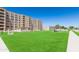 Exterior view of building with a green lawn, walkway and mature trees at 7970 E Camelback Rd # 604, Scottsdale, AZ 85251