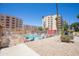Community pool area with lounge chairs, umbrellas, and gated entrance at 7970 E Camelback Rd # 604, Scottsdale, AZ 85251