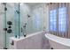 Bathroom featuring a glass shower and free-standing tub at 8214 N 16Th St, Phoenix, AZ 85020