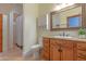 Bathroom featuring a vanity with granite counters, wood cabinetry, and walk-in shower at 8214 N 16Th St, Phoenix, AZ 85020