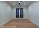 A spacious bedroom with hardwood floors, a ceiling fan, and white walls at 8214 N 16Th St, Phoenix, AZ 85020