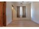 Bright, empty bedroom with wood-look floors, neutral walls, and a view of the backyard at 8214 N 16Th St, Phoenix, AZ 85020