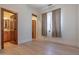 Bright bedroom featuring wood floors and wooden doorway to bathroom and closet space at 8214 N 16Th St, Phoenix, AZ 85020