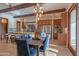 Dining space featuring hardwood floors, statement lighting, and a view of the kitchen with stainless steel appliances at 8214 N 16Th St, Phoenix, AZ 85020