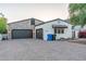 Charming home with a paved driveway leading to a two-car garage with a combination of siding and stone at 8214 N 16Th St, Phoenix, AZ 85020