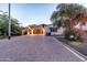 Charming home exterior with a paved driveway, stone accents, and a well-manicured landscape at 8214 N 16Th St, Phoenix, AZ 85020