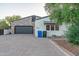 Charming home exterior with stone accents, a gray garage door, and desert landscaping at 8214 N 16Th St, Phoenix, AZ 85020