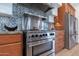 Up close of a stainless steel stove, with a decorative backsplash and wood cabinets at 8214 N 16Th St, Phoenix, AZ 85020