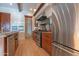 Kitchen showcases a granite counter, stainless steel appliances, custom cabinets, and hood with a decorative tile backsplash at 8214 N 16Th St, Phoenix, AZ 85020
