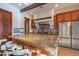 The kitchen features granite countertops, stainless steel appliances, a tile backsplash, and counter seating at 8214 N 16Th St, Phoenix, AZ 85020