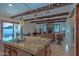 Open-concept living space with exposed beams, stone fireplace, and views of the pool and outdoor area at 8214 N 16Th St, Phoenix, AZ 85020