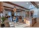 Open living and dining area showcasing wooden beams, stone fireplace, hardwood floors and statement light fixture at 8214 N 16Th St, Phoenix, AZ 85020