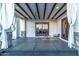 Covered outdoor patio with dark wood beams, a ceiling fan, and access to the home through a sliding glass door at 8214 N 16Th St, Phoenix, AZ 85020