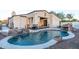 Backyard pool with a waterfall feature, lounge area, and covered patio, perfect for relaxing and entertaining at 8214 N 16Th St, Phoenix, AZ 85020