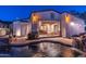Inviting outdoor pool with elegant lighting and rock waterfall feature creating a backyard paradise at 8214 N 16Th St, Phoenix, AZ 85020