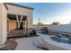 Backyard pool area with a covered patio, stone accents, a waterfall, and a Buddha statue at 8214 N 16Th St, Phoenix, AZ 85020