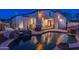 A backyard with a pool, a waterfall feature, a covered patio and exterior lighting for evening enjoyment at 8214 N 16Th St, Phoenix, AZ 85020