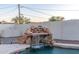 Backyard pool with a tranquil waterfall feature and surrounding greenery creating a peaceful oasis at 8214 N 16Th St, Phoenix, AZ 85020