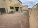 Spacious backyard with gravel, an AC unit, and a covered patio area at 9456 W Jamestown Rd, Phoenix, AZ 85037