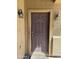 Close-up of a solid brown front door with side lanterns and a neutral colored facade at 9456 W Jamestown Rd, Phoenix, AZ 85037