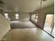 Open-concept living room with large windows and a sliding glass door at 9456 W Jamestown Rd, Phoenix, AZ 85037