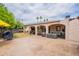 This shot of the backyard showcases a large covered patio and outdoor seating with a big yard at 10601 N 36Th St, Phoenix, AZ 85028
