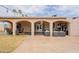 The large covered patio features an outdoor seating area with mature landscaping and an arched doorway at 10601 N 36Th St, Phoenix, AZ 85028