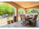 This shot of the covered patio shows outdoor dining and backyard landscaping at 10601 N 36Th St, Phoenix, AZ 85028