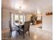 Elegant dining room featuring a wooden table, tile floors, and a sliding glass door to the outside at 10601 N 36Th St, Phoenix, AZ 85028