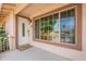 Inviting front porch with white door and window, creating a warm and welcoming entrance at 10601 N 36Th St, Phoenix, AZ 85028