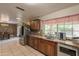 Bright kitchen with stainless steel appliances, granite countertops, and breakfast bar at 10601 N 36Th St, Phoenix, AZ 85028