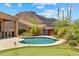 Inviting backyard featuring a sparkling pool, putting green, and lush desert landscaping at 11324 E Diamond Cholla Dr, Scottsdale, AZ 85255