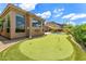 Beautiful home exterior with a putting green, complemented by the scenic mountain views in the background at 11324 E Diamond Cholla Dr, Scottsdale, AZ 85255