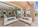 View of covered patio from seating area, showcasing the home's indoor-outdoor flow at 11324 E Diamond Cholla Dr, Scottsdale, AZ 85255