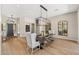 Spacious dining room with a large table, modern lighting, and hardwood floors at 11324 E Diamond Cholla Dr, Scottsdale, AZ 85255